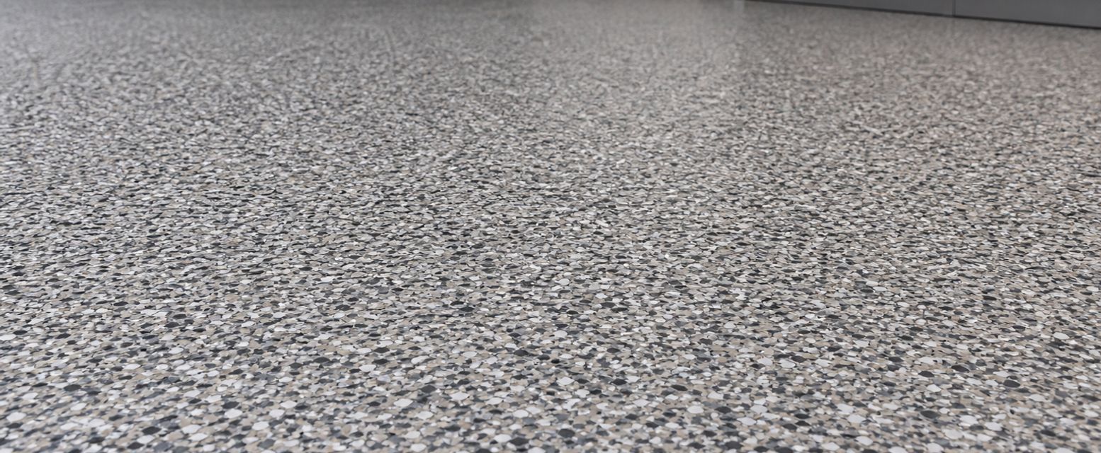 Close view of a gray decorative flake epoxy floor