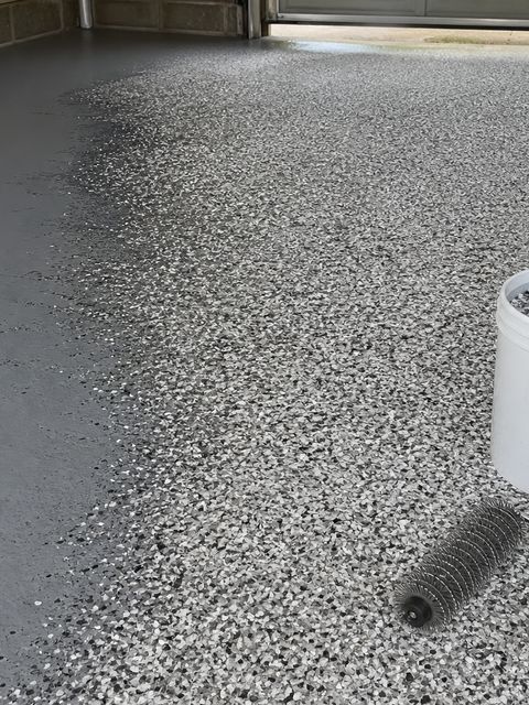Contractor broadcasting decorative flakes over wet epoxy