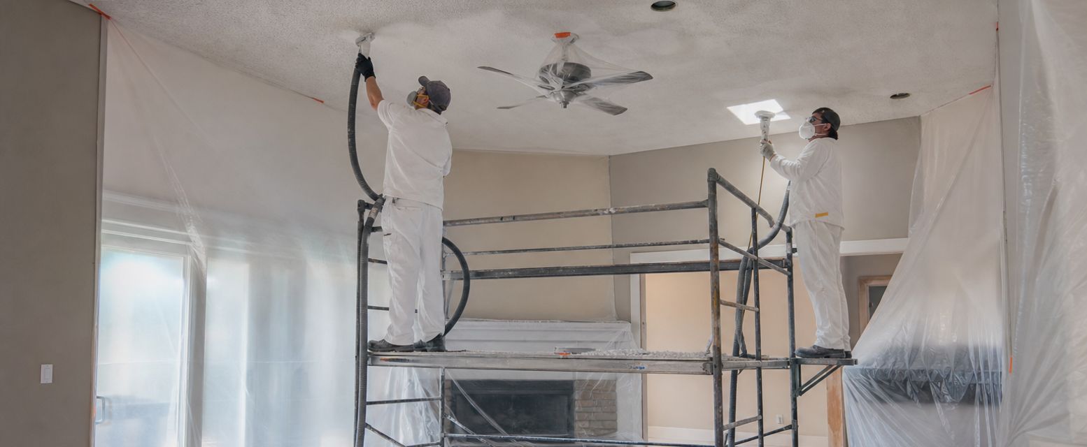 Acoustic ceiling being removed by a crew