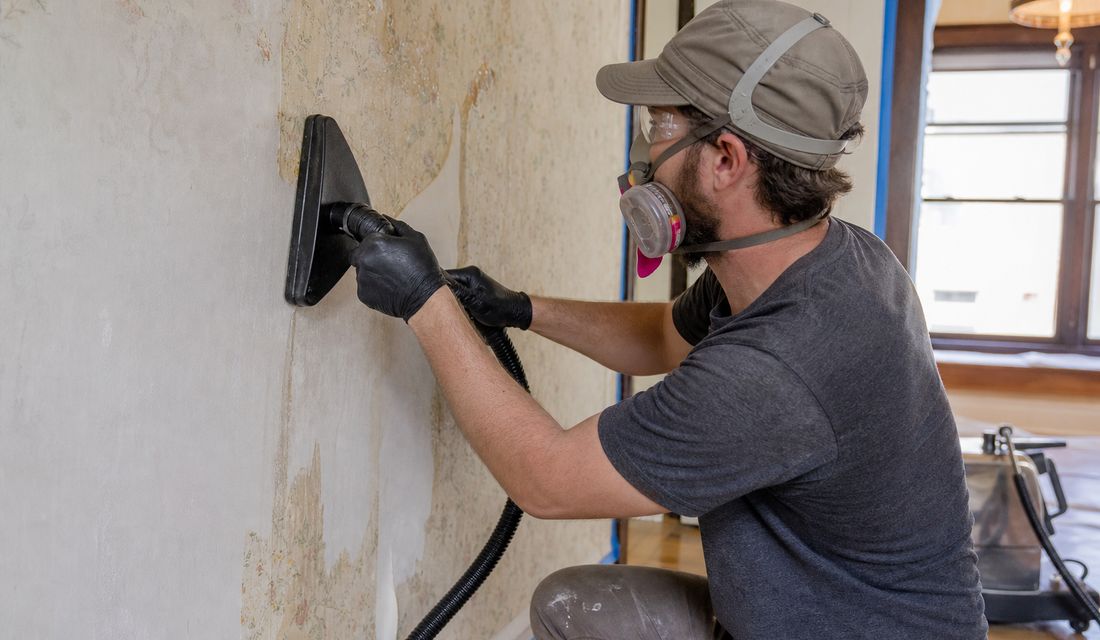 Wallpaper coming off a plaster wall